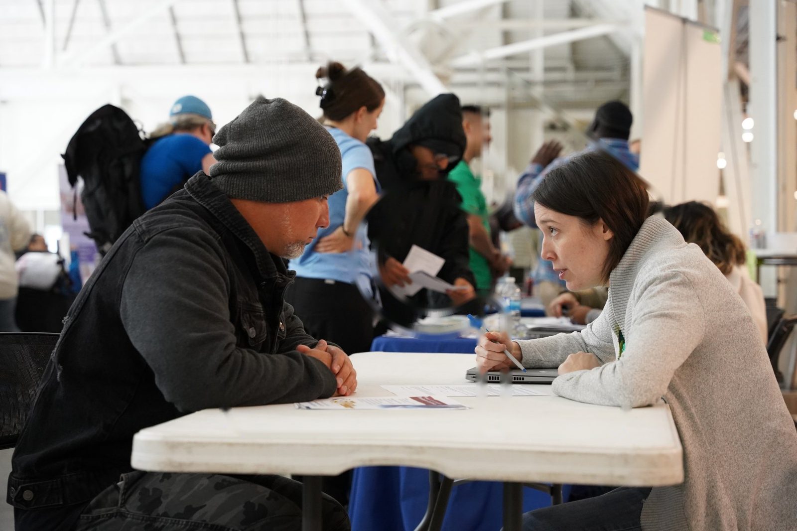 Frontline worker in conversation with a community member at an HCT event
